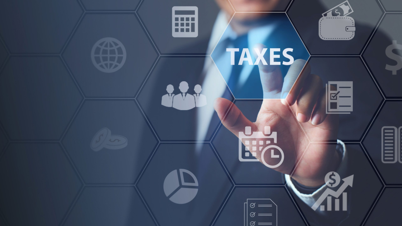 Businessman using innovative virtual touchscreen presses taxes button.with icons state taxes.Data analysis,paperwork,financial research,report.Calculation tax return surrounding.taxes Concept